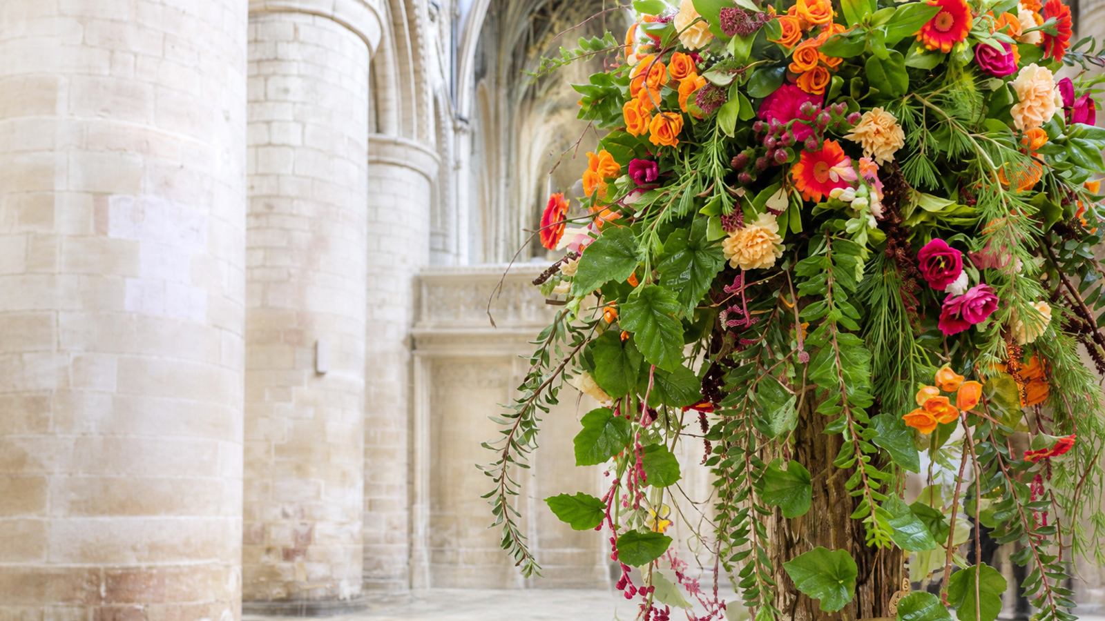 Colourful floral installation displayed inside Gloucester Cathedral.