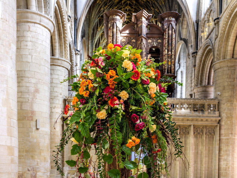Colourful floral installation displayed beneath the arches
